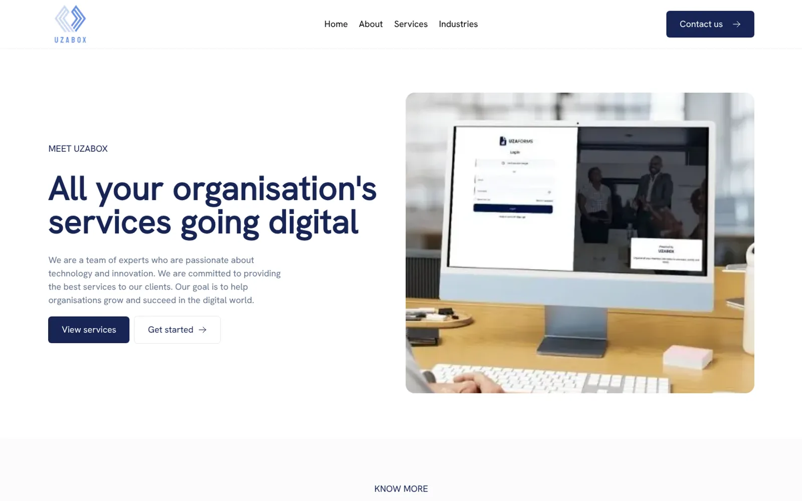 Uzabox website: all your organisation’s services going digital, next to a desktop computer